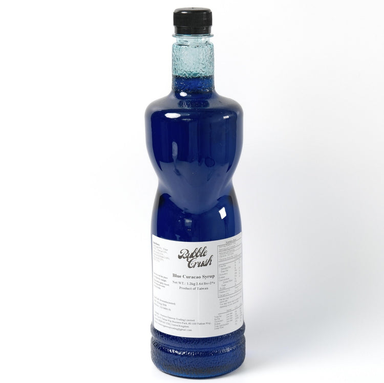 Vibrant blue Blue Curacao syrup being poured, highlighting the vivid colour and smooth liquid texture.