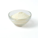 Refreshing Lychee milk tea drink being prepared instantly from the rapid-dissolve powder, showing light pink colour.