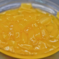 Close-up of Mango Nata de Coco, versatile, ready-to-use cubes for fast-serve foodservice in large bucket.