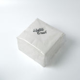 Premium napkin placed next to a bubble tea drink, demonstrating suitability for café and quick service use.