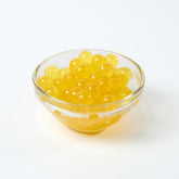 Wholesale Passion Fruit Popping Boba, tangy Bursting Boba topping for UK bubble tea bulk supply.