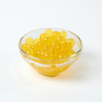 Wholesale Passion Fruit Popping Boba, tangy Bursting Boba topping for UK bubble tea bulk supply.