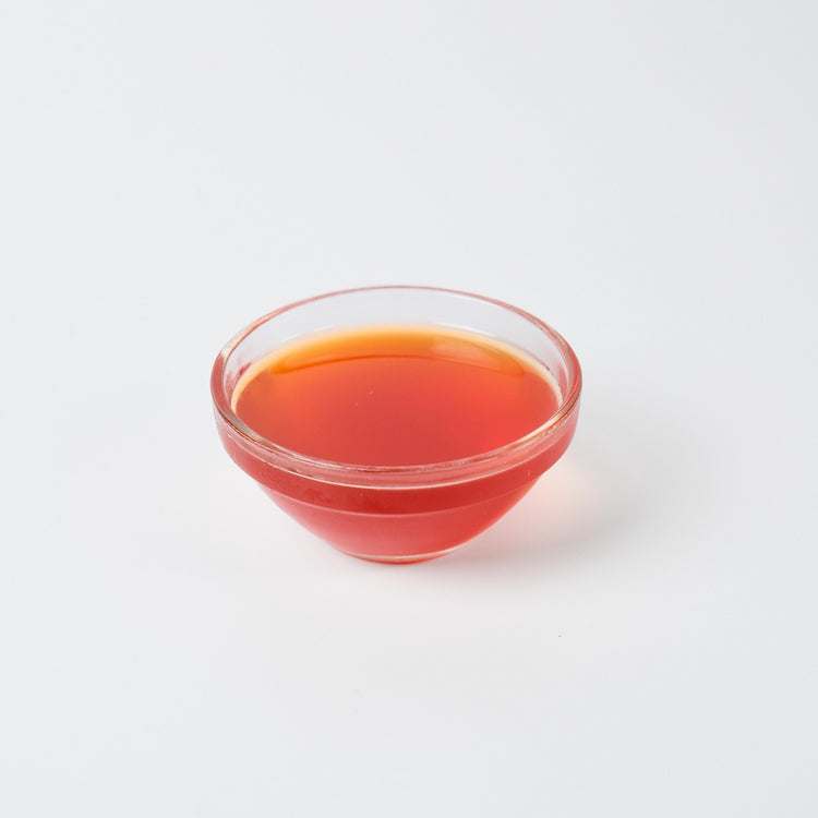 1.2L bottle of Premium Vegan Pomegranate Syrup, a tart fruit flavouring for bubble tea and cocktails in the UK.