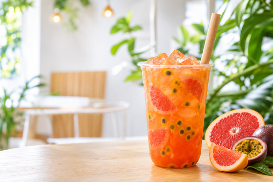 Red grapefruit passion fruit iced tea in a clear takeaway cup for a UK bubble tea shop