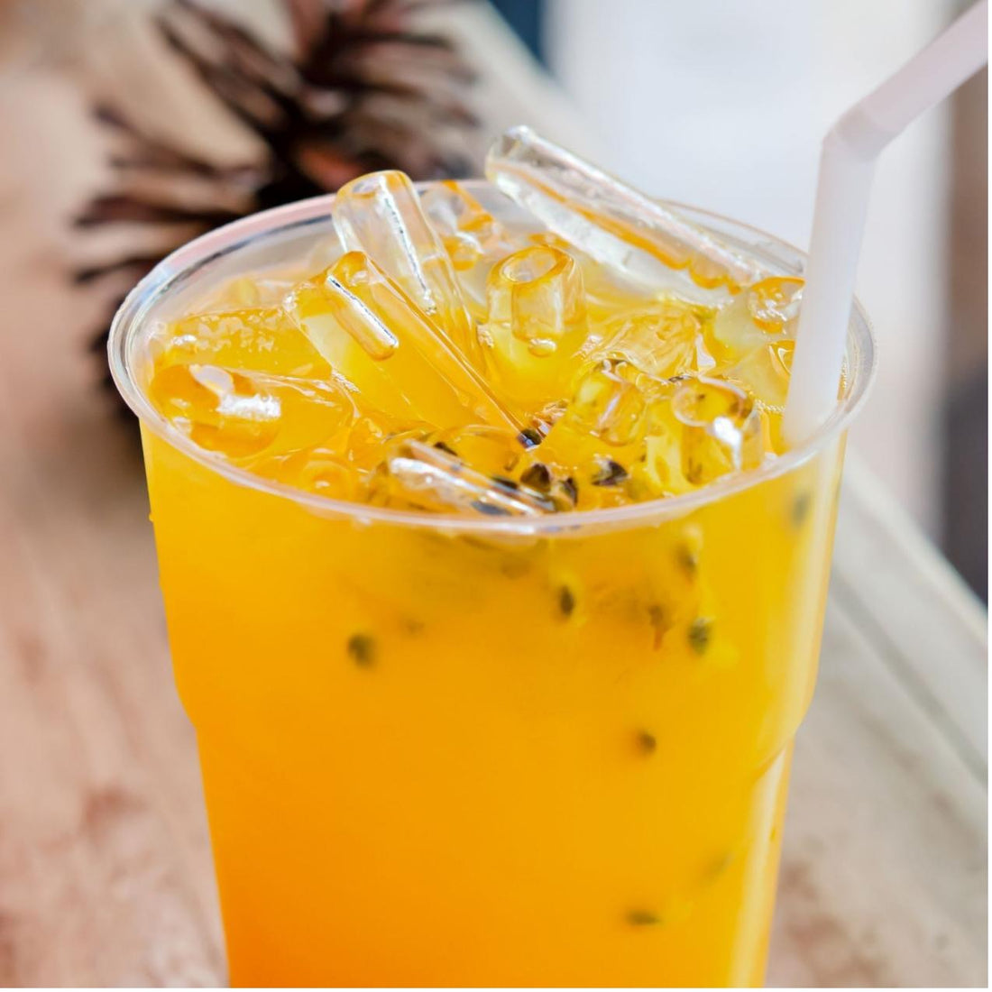 Refreshing passion fruit bubble tea with tapioca pearls and popping boba – a tropical delight.