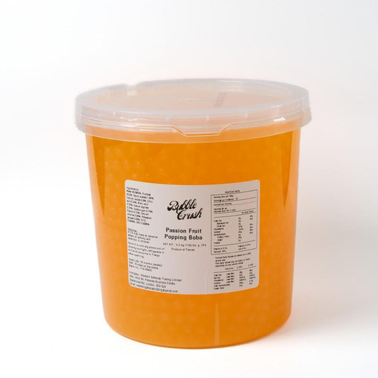 Close-up of Passion Fruit Boba, vibrant yellow ready-to-use ingredient in large commercial bucket for foodservice.