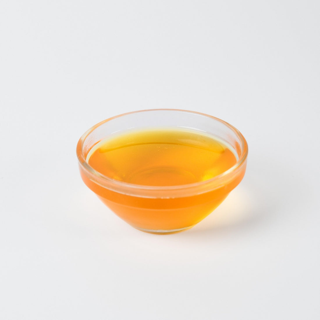 Bright yellow Pineapple syrup being poured, highlighting its liquid consistency and vibrant tropical colour.