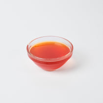 1.2L bottle of Premium Vegan Pomegranate Syrup, a tart fruit flavouring for bubble tea and cocktails in the UK.